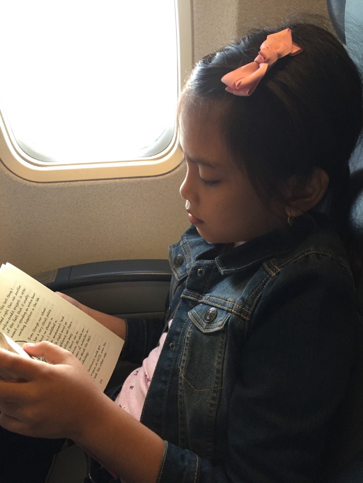 Laaija reads in the plane)